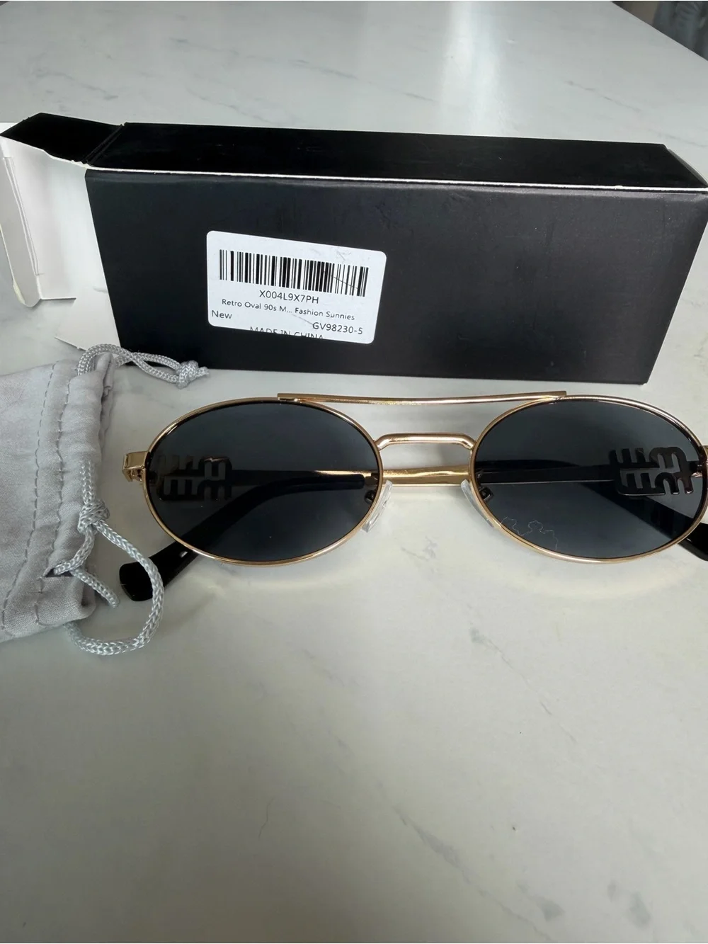Gold Frame Oval Sunglasses with Black Lenses